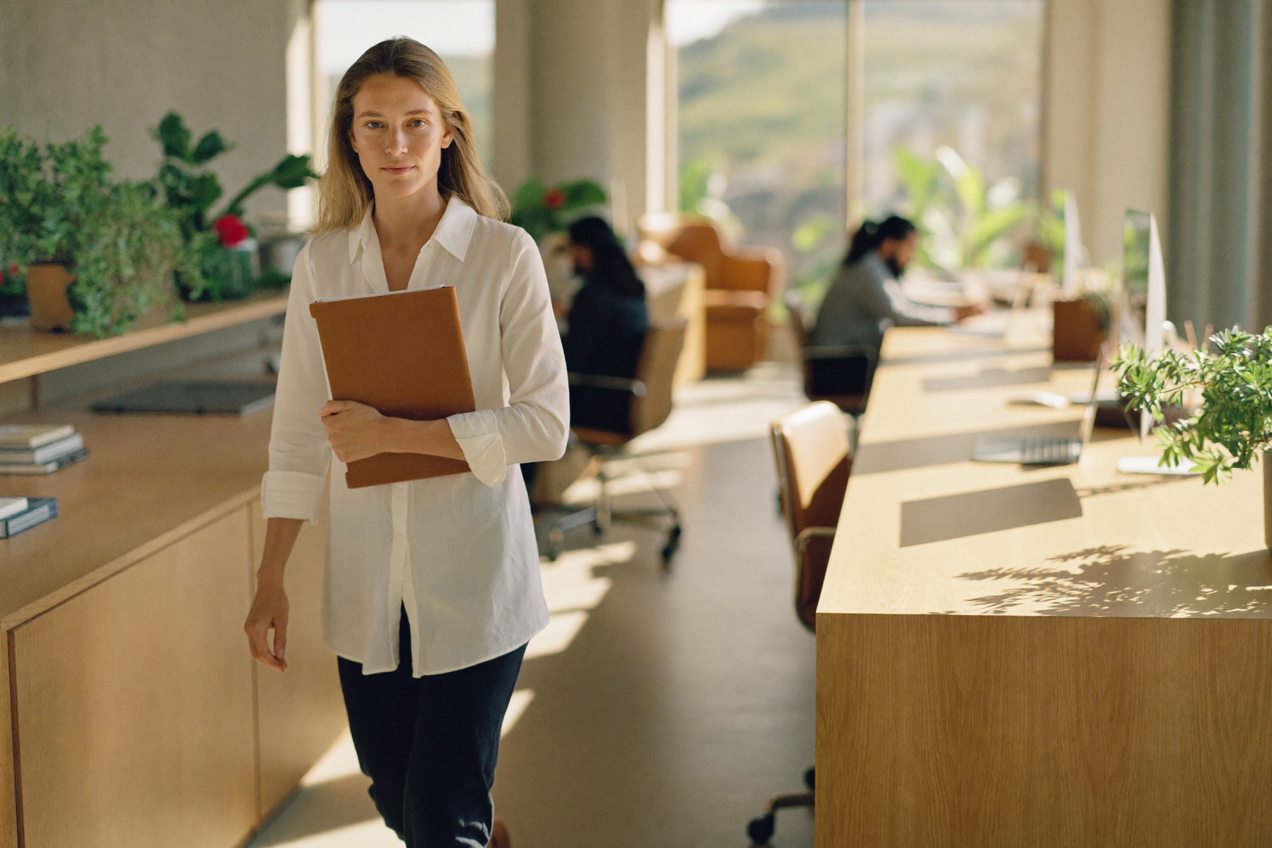 Office manager coordinating a team day in a busy open office